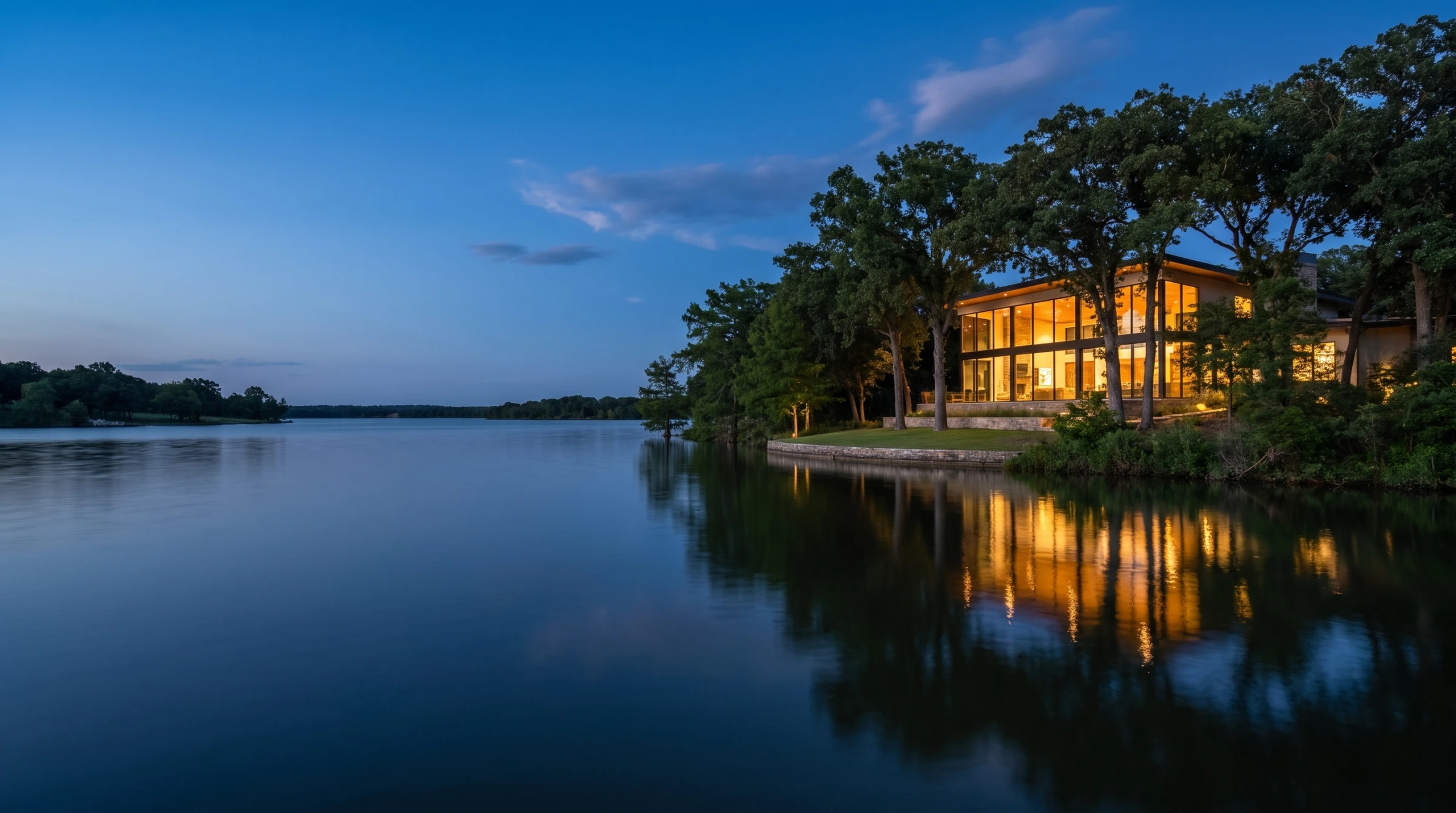 Illustrative concept view of a contemporary lakeside residence at Cypress Point at blue hour